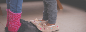 child stepping onto adult feet