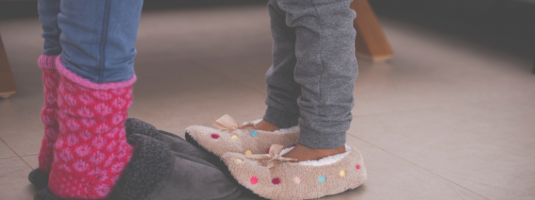 child stepping onto adult feet